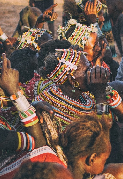 Three Maasai men wearing the distinctive shuka cloth in Kenya